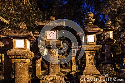 Lighted stone lanterns at night in Kasuga Taisha shrine in Nara, Japan. UNESCO World Heritage Site Editorial Stock Photo