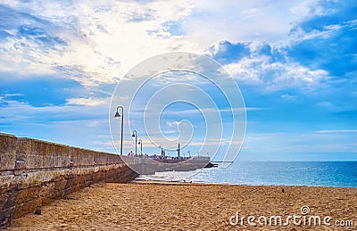 The stone levee of San Sebastian Castle from La Caleta beach, Cadiz, Spain Stock Photo