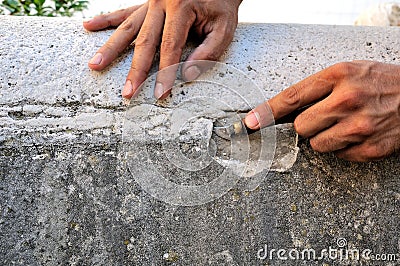 Stone mason at work carving an ornamental relief Stock Photo