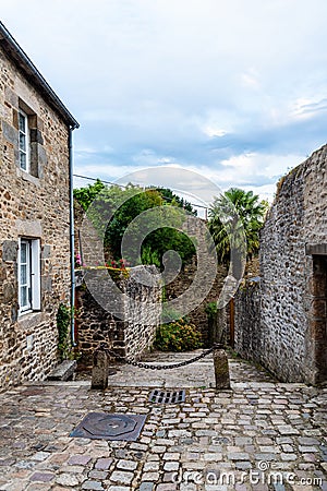 Stone medieval houses in cobblestoned street in Dinan Stock Photo