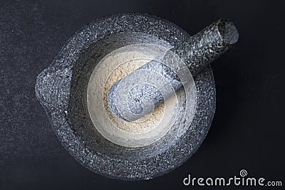 Stone Mortar and Pestle with Dried Onion Stock Photo