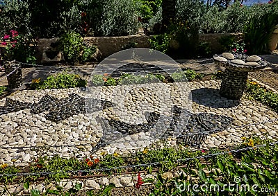 Stone mosaic composition, two fish and five loaves of bread, Church of Mount of Beatitudes, Israel Editorial Stock Photo