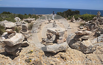 Girl walking next to Stone mounts in the south coast of the island of majorca Stock Photo