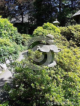 Stone Pagoda path lanterns in bright sunshine Stock Photo