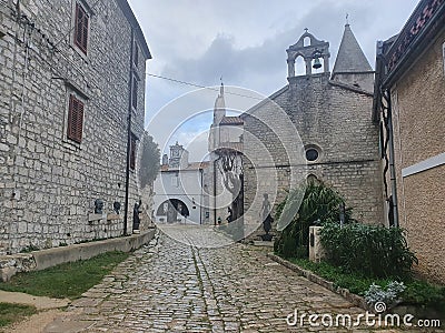 a stone path among old gray stone houses Stock Photo