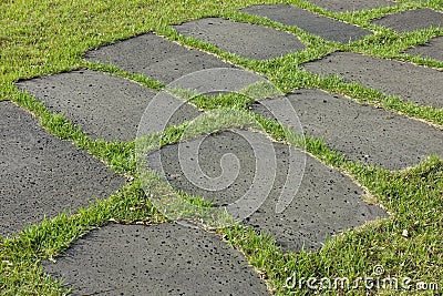 Stone paved road with grass Stock Photo