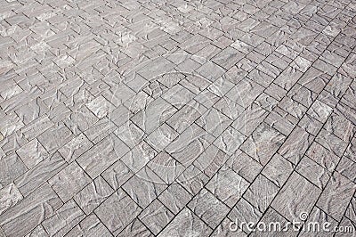 Stone pavement in perspective. Stone pavement texture. Granite cobblestoned pavement background. Abstract background of Stock Photo