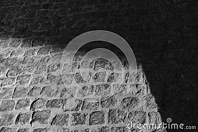 On the stone pavement, which is more than 300 years old, light plays with the shadow. Stock Photo