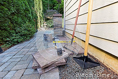 Stone Pavers and Tools for Side Yard House Landscaping Stock Photo