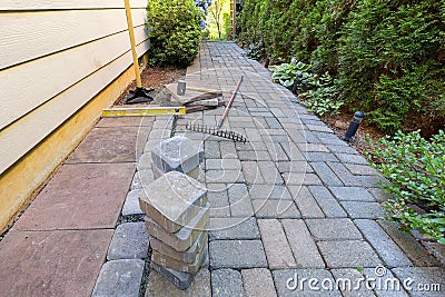 Stone Pavers and Tools for Side Yard Landscaping Stock Photo