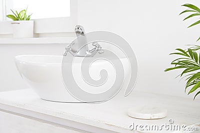 Stone pedestal for product display near vessel sink in bathroom Stock Photo