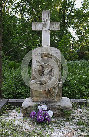 Stone pedestal of the statue of tombstones in the old cemetery. tomb sculpture monument to the mother of the mourner and cross. Stock Photo