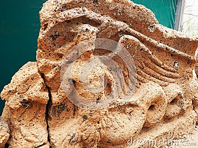 Stone pediment featuring a siren from over an Etruscan tomb entrance Stock Photo