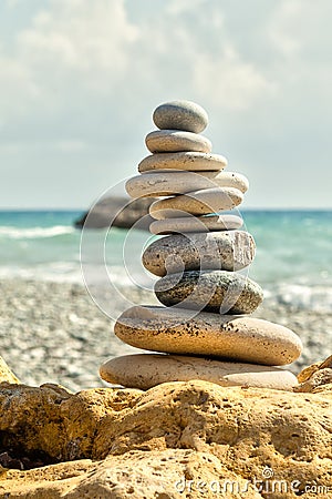 Stone pile on yellow sandstone by the shore Stock Photo