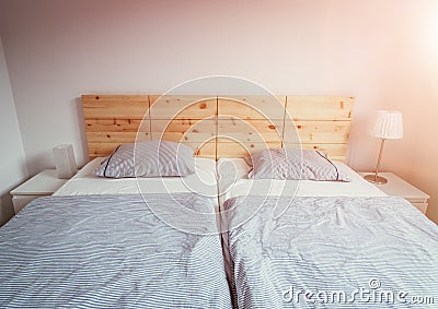 Stone pine bed: Empty wooden bed with pillow and blanket Stock Photo