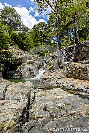 Stone pond with a waterfall of an old forest. Stock Photo