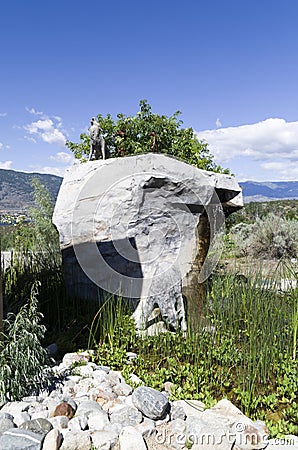 Stone sculpture of a bear getting a drink of water Editorial Stock Photo