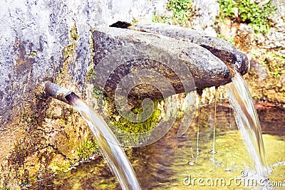 Stone source of drinking water comes from a mountain - image with copy space Stock Photo