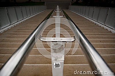 Stone stair with a chrome railing in the middle Stock Photo