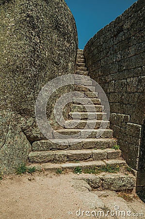 Stone staircase between wall and big rock at the Castle of Monsanto Stock Photo