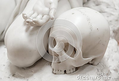 Stone statue of human skull with hand Stock Photo
