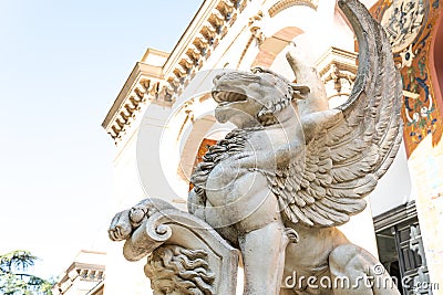 Stone statue of a winged wolf at the entrance of a palace Editorial Stock Photo