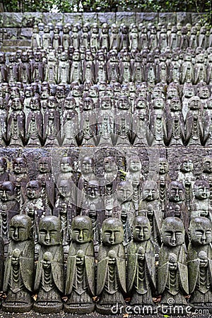 stone statues of Ksitigarbha bodhisattva (Jizo) at Hasedera Temple, Kamakura, Japan on a rainy day Stock Photo