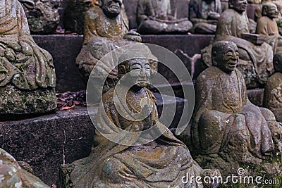 Stone statues of a seated Buddhist monks close-up Stock Photo