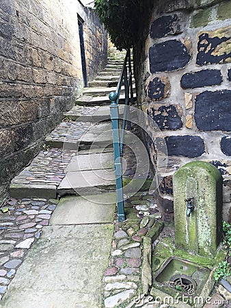 Stone steps in alley way with railing from seaside town uk Stock Photo