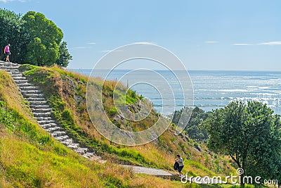 Stone steps down track up Mount Maunganui with view beyond to Pacific Ocean Editorial Stock Photo