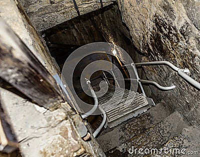 Staircase in the dungeon. Stone steps to the basement. Stock Photo