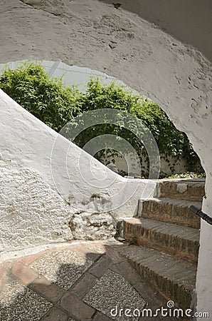 Stairs under white arch Stock Photo