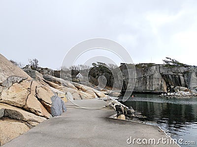 Stone surface joining rocky hills by the water in Ranvika, Norway Stock Photo