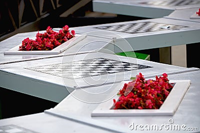 Stone tables with chess boards for playing chess outdoors in the Park. Leisure and entertainment for visitors to the Park Stock Photo