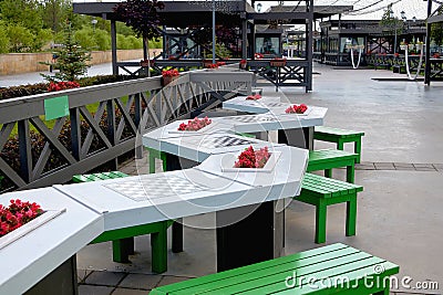 Stone tables with chess boards for playing chess outdoors in the Park. Leisure and entertainment for visitors to the Park Stock Photo