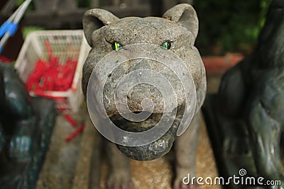 Stone tiger with emerald eyes Stock Photo