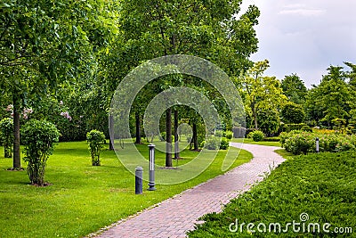 Stone tile walkway curve arcing in the park. Stock Photo