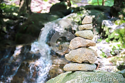 Stone tower rocks arranged at waterfall, Zen balance concept Stock Photo