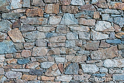 Ancient stone wall built by hand Stock Photo