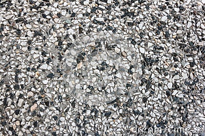 Stone wall background texture. Pebble texture in concrete, small pebbles on the wall. Stock Photo