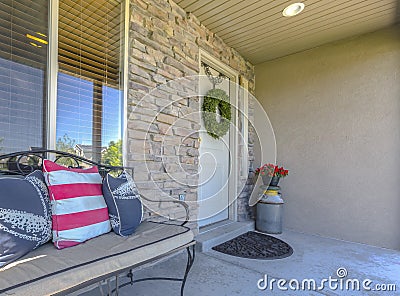 Stone wall entry with bench near front door Stock Photo