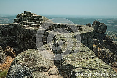 Stone wall on hilltop covered by rocks at the Castle of Monsanto Stock Photo