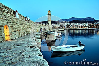 Stone wall and historic lighthouse in the port of Rethymnon Stock Photo
