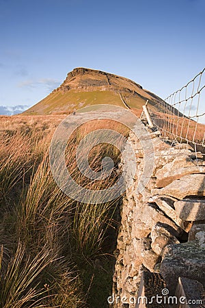 Stone wall leading up to Pen-y-Ghent in Yorkshire Dales National Stock Photo
