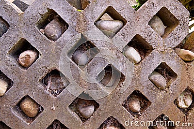 Stone wall with rocks in holes and spiderwebs - Garden Stock Photo