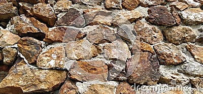 Stone wall. Stacked large cobblestones in warm colors. Tower in Kula, Serbia Stock Photo