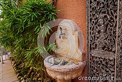 Stone water fountain, marble sink, built in house wall, mediterranean style Stock Photo