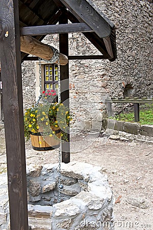 Stone well with flowers Stock Photo