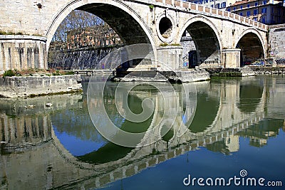 Bridge arches reflected in the river Stock Photo