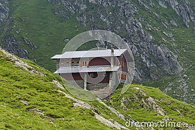 Stone and wood chalet on the mountain range Stock Photo